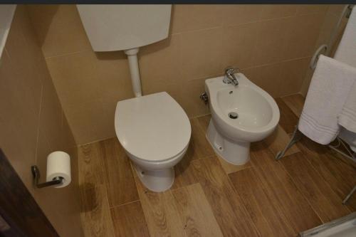 a bathroom with a toilet and a sink at Bed & breakfast vecchia vallata in Gioia del Colle