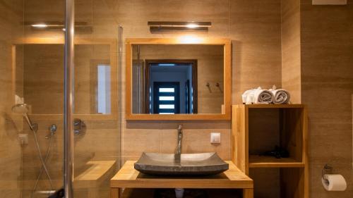 a bathroom with a sink and a shower with a mirror at Władysławowo apartament Natalia. in Władysławowo