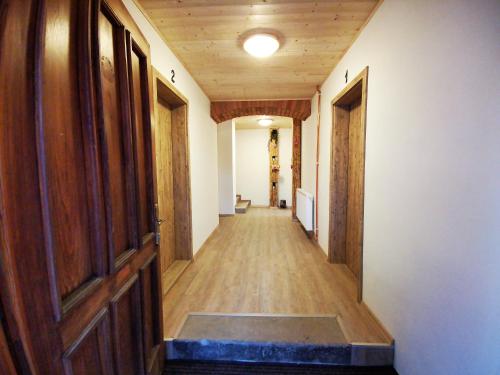 an empty hallway with wooden floors and doors at Penzion U Lípy in Ostrov