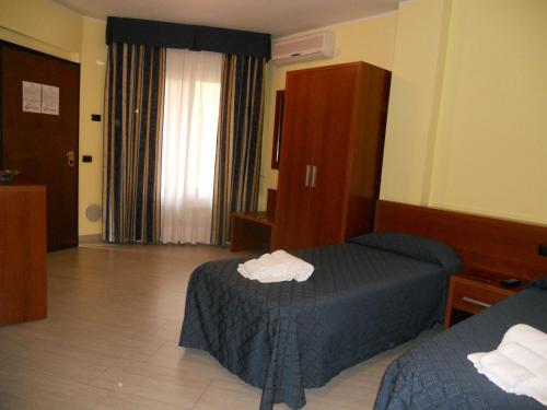 En eller flere senger på et rom på Residence San Prospero