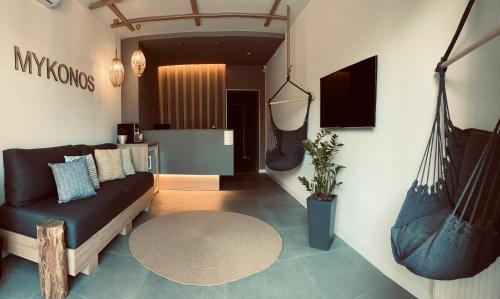 a living room with a couch and a table at Mykonos Hotel Apart - Maestro in Odesa