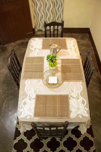 a table with two chairs and a table with flowers on it at Blissful Eyrie in Guwahati