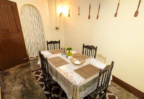 a dining room with a table and some chairs and a table and chairsktop at Blissful Eyrie in Guwahati
