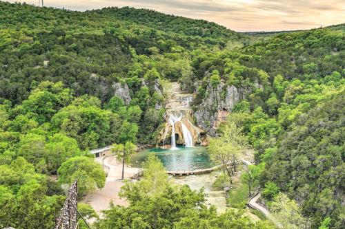 an aerial view of a waterfall in a forest at Cedar Falls Cabin 5 half Mile to Turner Falls in Davis
