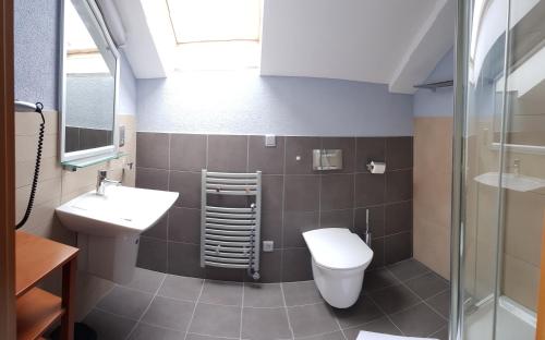 a bathroom with a toilet and a sink at Apartmány Puerto in Senec