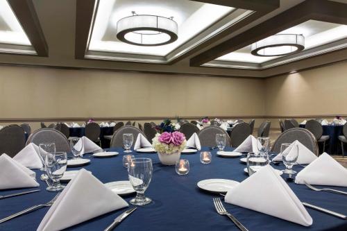 a conference room with a long table with blue table cloth at Crowne Plaza Atlanta - Midtown by IHG in Atlanta