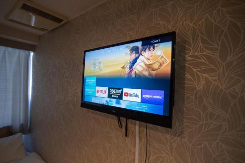 a flat screen tv hanging on a wall at Vail sta Takenotsuka in Tokyo