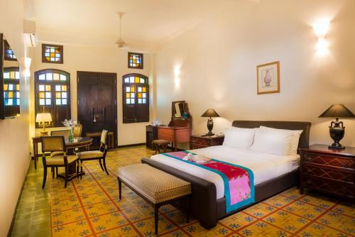 a hotel room with a bed and a table and chairs at Areca Hotel Penang in George Town
