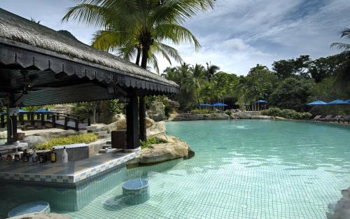 a large swimming pool in a tropical setting at Berjaya Langkawi Resort in Pantai Kok