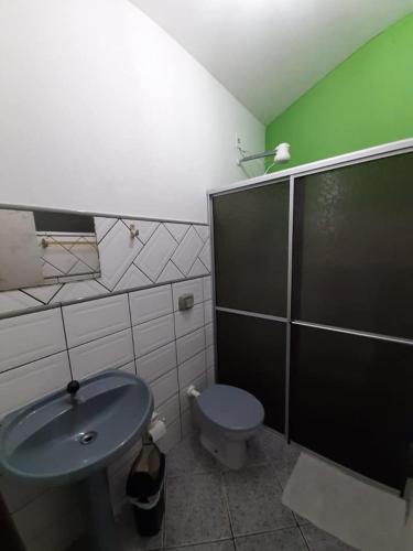 a bathroom with a toilet and a sink and a shower at Hotel Paulista in Barra Velha
