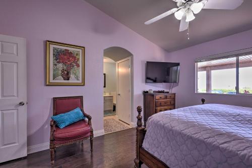 a bedroom with purple walls and a bed and a tv at Pool Home with Spectacular Strip and Mountain Views! in Las Vegas