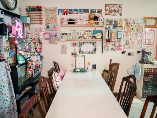 a dining room with a long table and chairs at Red Letter Day in Tainan
