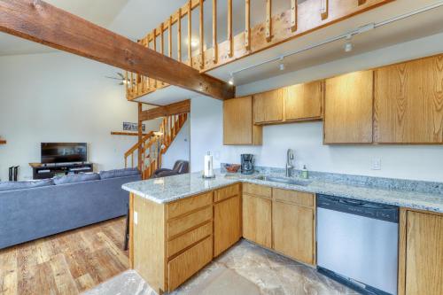 a kitchen with wooden cabinets and a living room at Buffalo Ridge Condos in Silverthorne