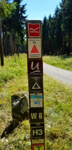 a pole with signs on the side of a road at Ferienwohnungen Tannenhof in Willingen