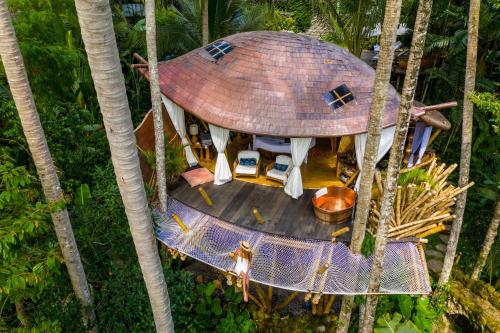 an overhead view of a tree house in the forest at Stone House in Ubud