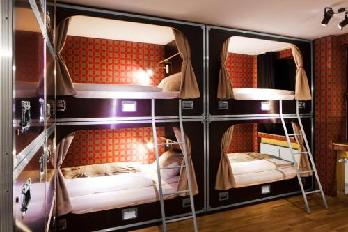 a room with three bunk beds in it at Hostel die Wohngemeinschaft in Cologne