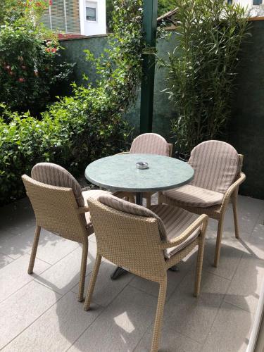 three chairs and a table and a table and chairs at Apparthotel Gartenresidence Nalserhof in Nalles