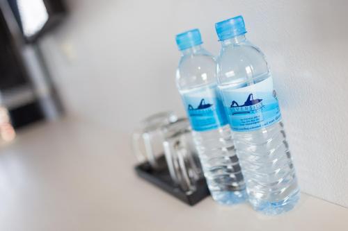 two bottles of water sitting on top of a counter at The Gene in Krabi town