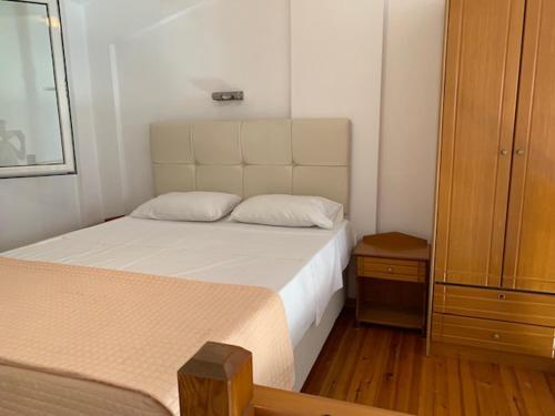 a small bedroom with a bed and a dresser at Kassiopi Bay in Kassiopi
