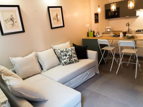 a living room with a couch and a kitchen at La CasAffittiera Apartments Group in Anzio
