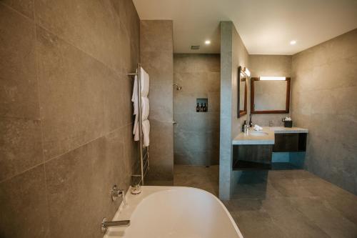a bathroom with a tub and a sink at Stoneridge Estate in Queenstown