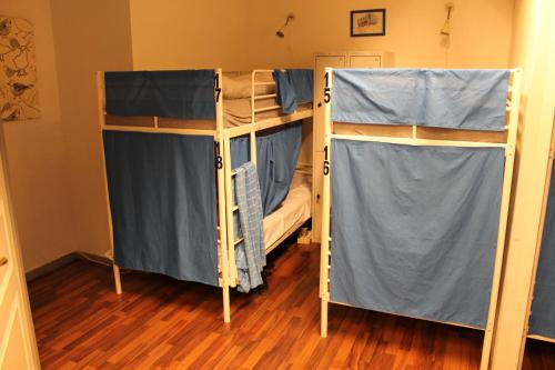 two bunk beds in a room with wooden floors at City Lodge Stockholm in Stockholm