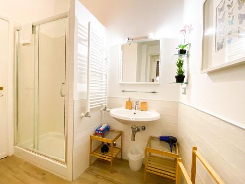 a bathroom with a sink and a shower at Butterfly Suite Rome in Rome