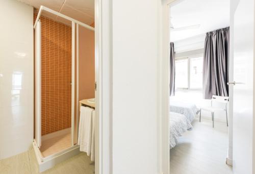 a bedroom with a mirror and a bed in a room at Flats Friends Atlantida in Benidorm
