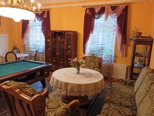 a living room with a table and a pool table at Вілла Графа in Lviv