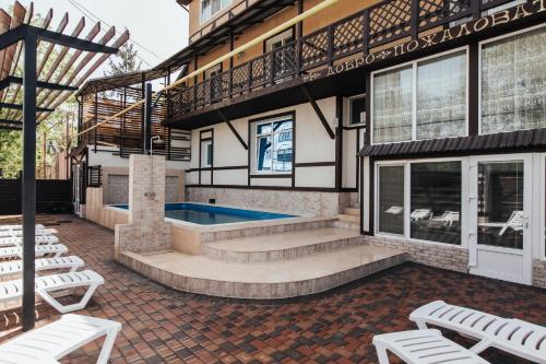 a patio with a swimming pool and a building at Guest House Lyudmila in Feodosia