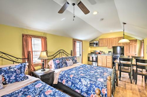 a bedroom with two beds and a kitchen at Pleasant Mount Studio with Pool Access, Near Skiing! in Pleasant Mount