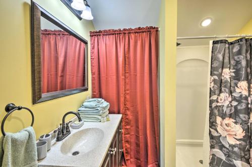 a bathroom with a sink and a red shower curtain at Pleasant Mount Studio with Pool Access, Near Skiing! in Pleasant Mount