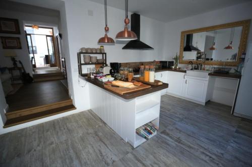 a kitchen with a sink, stove, and cabinets at Casa Rural Miller's of Frigiliana in Frigiliana