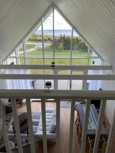 an attic view of a room with a large window at Merekalda Puhkemaja in Orjaku