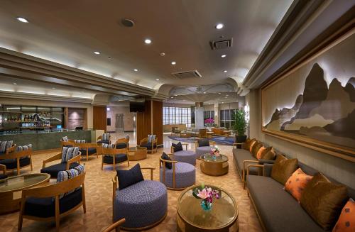 a hotel lobby with couches and tables and a bar at ANA Crowne Plaza Resort Okinawa Uruma Hills By IHG in Uruma