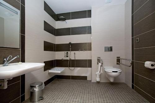 a bathroom with a sink and a toilet at Penzion Na Hvězdě in Ústí nad Labem