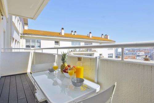 a balcony with a table with drinks on it at Studio Arché - Welkeys in Biarritz