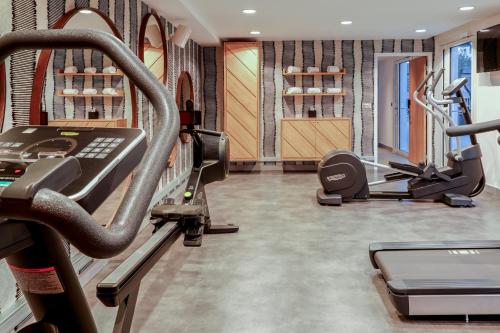 a gym with two treadmills and a treadmill at Mercure Marseille Centre Prado Vélodrome in Marseille
