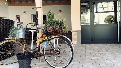 a bike with plants in baskets parked in front of a house at Hotel Engel in Kappel-Grafenhausen