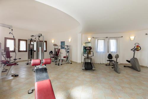 a gym with treadmills and machines in a room at Hotel Mon Repos in Baja Sardinia