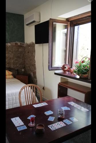 a room with a table and a bed and a table with cards on it at B&B Home Holiday Villa delle Acacie agriturismo in Sala Consilina