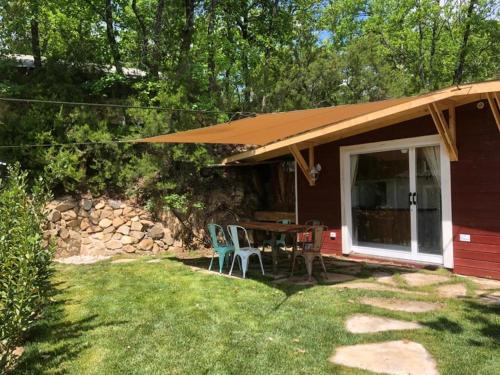 a house with a table and chairs in the yard at Camping Barco Reale in Lamporecchio