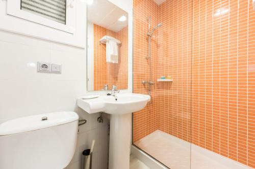 a bathroom with a sink and a toilet and a shower at Flats Friends Atlantida in Benidorm