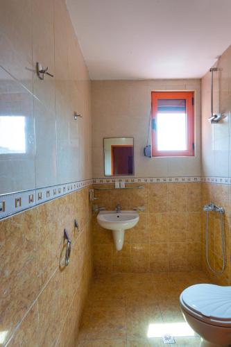 a bathroom with a sink and a toilet at Family Hotel Jemelly in Obzor