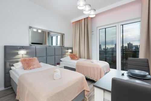 a hotel room with two beds and a window at Apartments with parking Warsaw Business Center by Renters in Warsaw