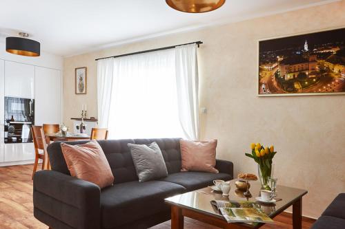 a living room with a couch and a table at APARTAMENT GOLD in Bielsko-Biała