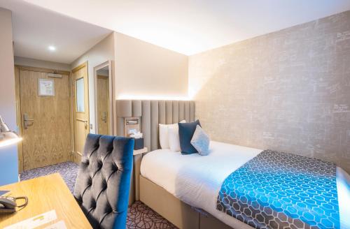 a hotel room with a bed and a desk at The Scholar in Edinburgh