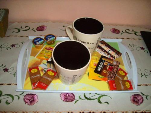 a tray with two cups of coffee and candy at Twins Studios in Benitses
