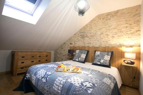 a bedroom with a bed with a tray of fruit on it at La Ferme du Cayla in Linac