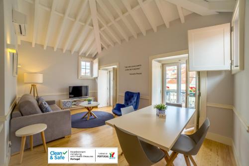a living room filled with furniture and a large window at Villa Baixa - Lisbon Luxury Apartments in Lisbon